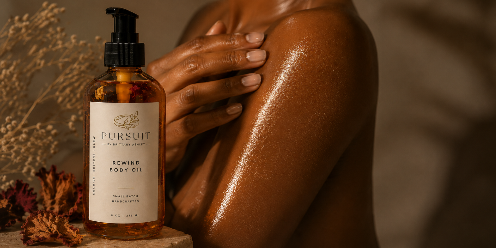 Person holding a bottle of Pursuit Rewind Body Oil with a blurred background